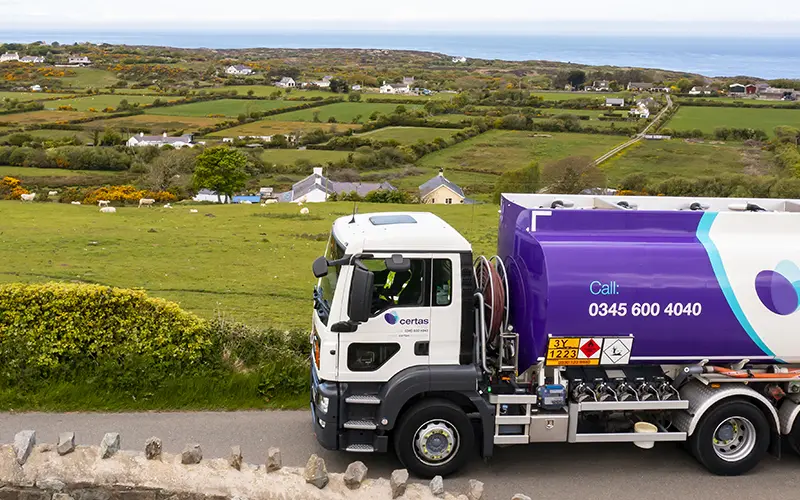 Certas Energy truck driving on rural road.